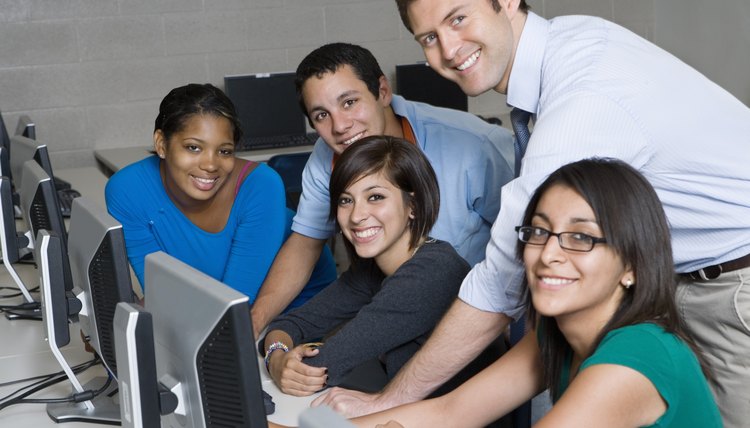 Classroom monitor helping students in the computer lab