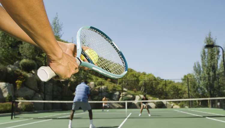 Tennis player serving tennis ball