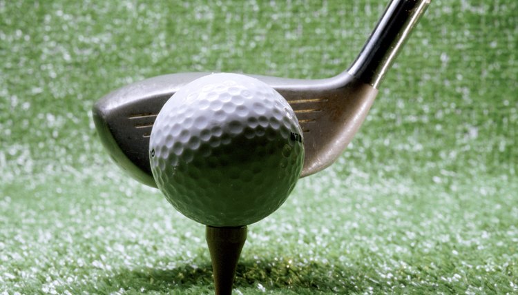 Close-up of a golf club next to a golf ball