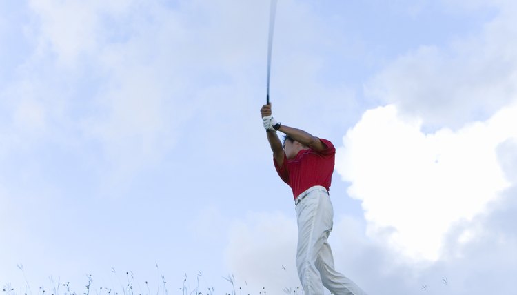 Man Swinging Golf Club