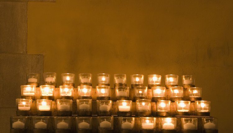 Votive candle racks hold remembrance of prayers.