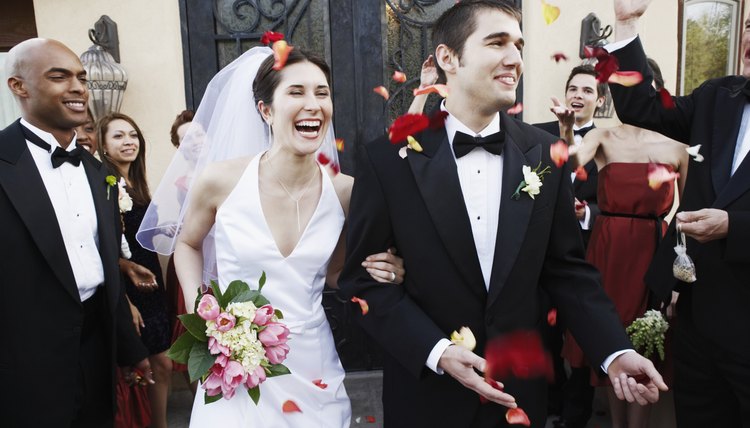 A bride and groom exit a church as husband and wife.