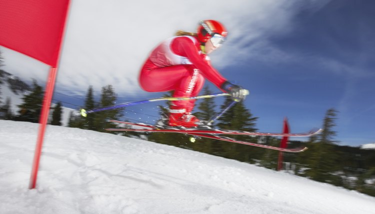 Female skier in giant slalom ski race (blurred motion)