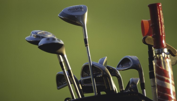 Close-up of golf clubs and an umbrella