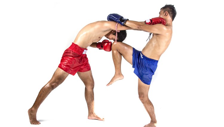 Two thai boxers exercising traditional martial art