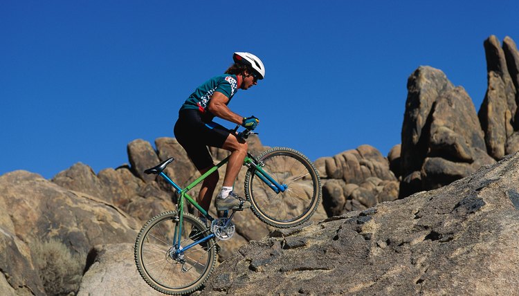 Man riding mountain bike on rocky terrain