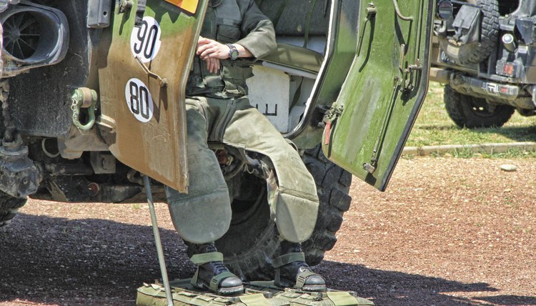 A man exiting a bomb squad vehicle.