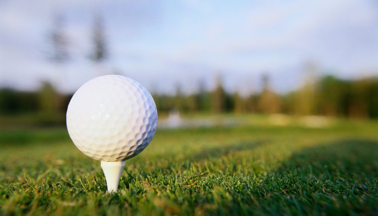 golf ball on tee with club