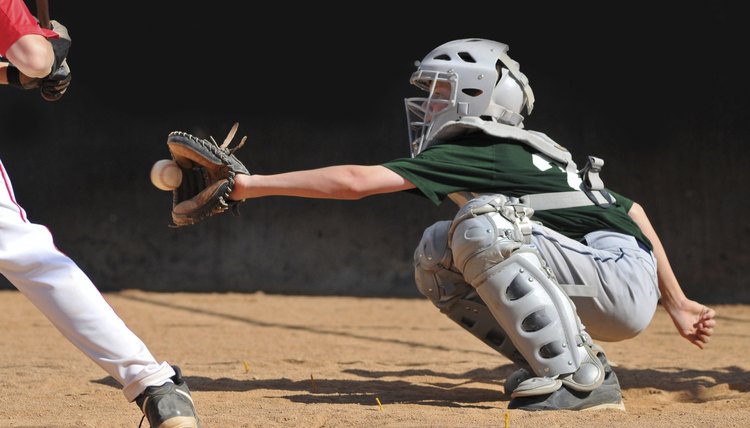 Teen boy plays baseball catcher