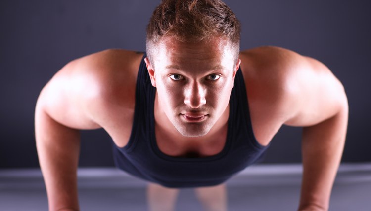 Fitness man doing push ups on floor