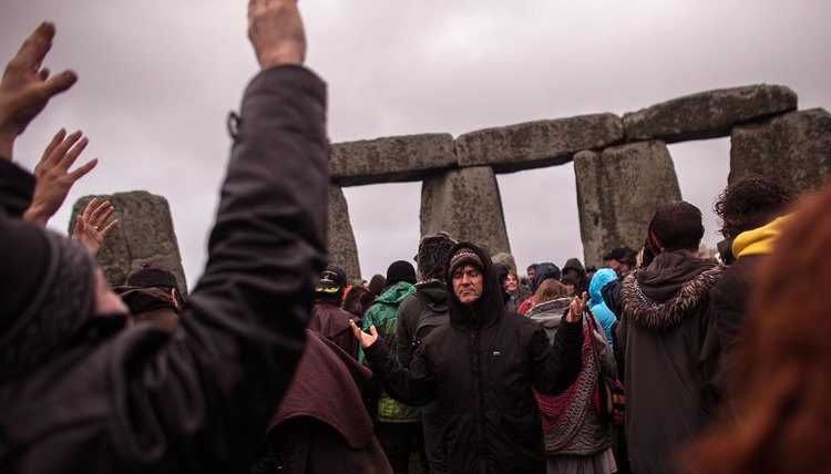 A gathering of pagans celebrating solstice at Stonehenge.