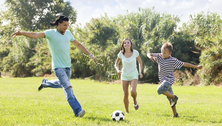 Family with teenager playing in soccer