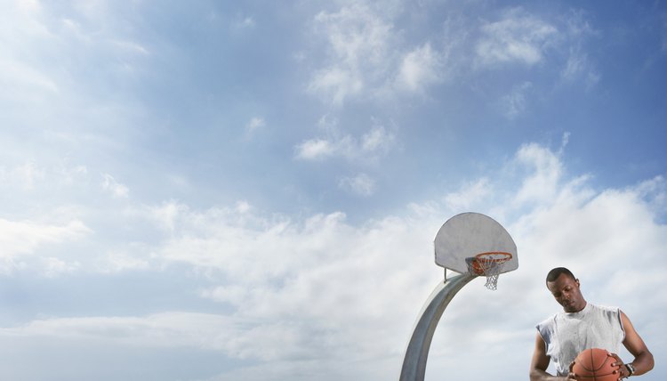 African man holding basketball