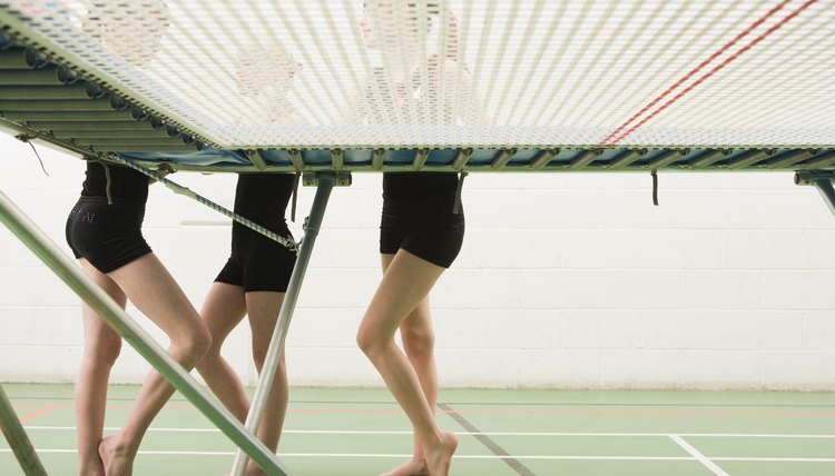 Gymnasts talking by trampoline