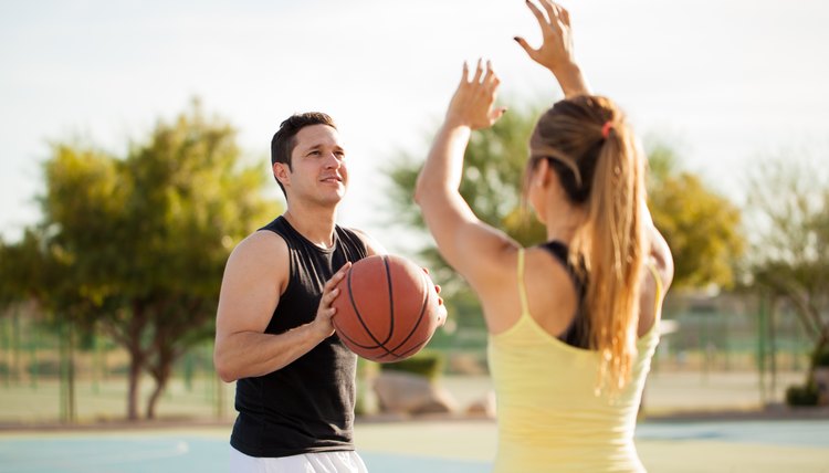 Cute couple playing basketball