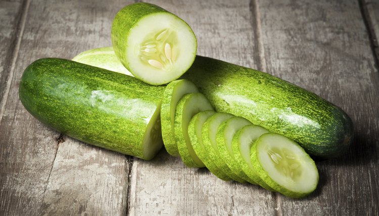 cucumber slices on wooden background