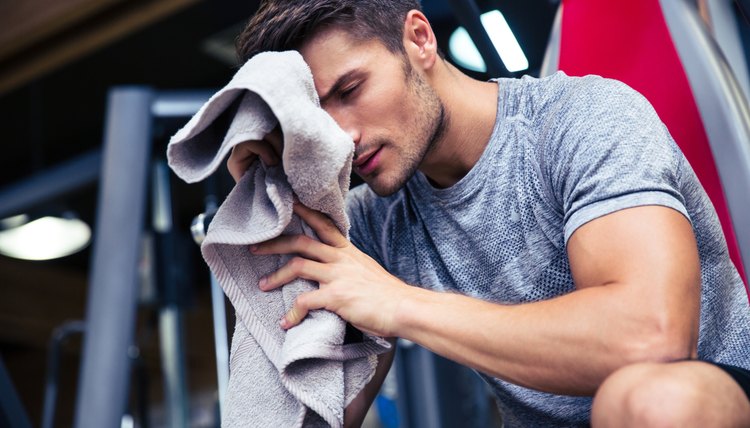 Man sitting on the bench with towel