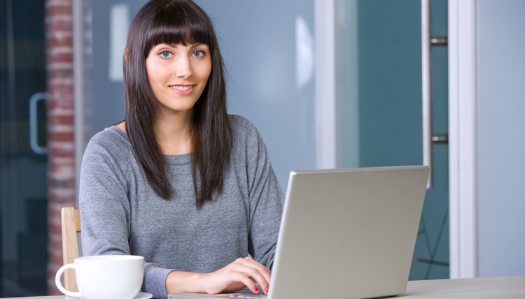 Young woman doing research on laptop