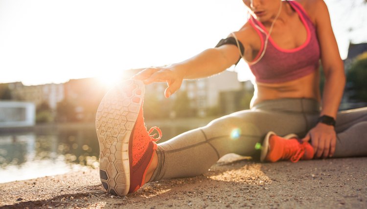 Runner athlete stretching legs