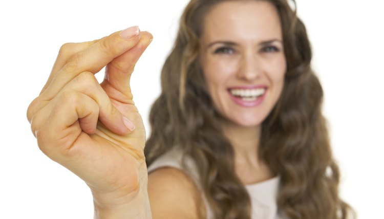 Closeup on smiling young woman snapping fingers