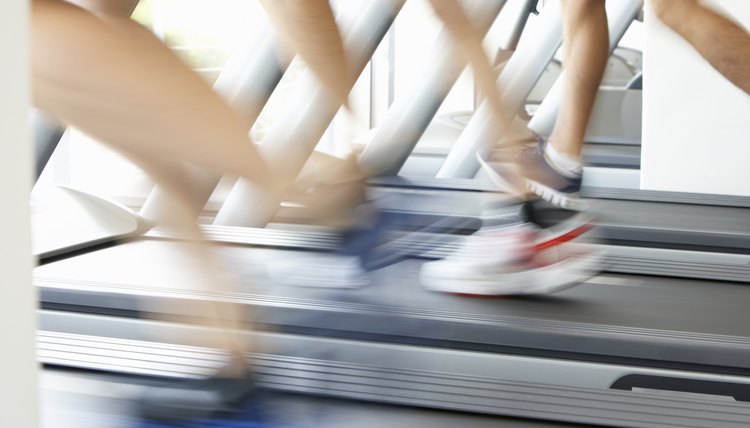 Close Up Of 3 Runners Feet  Running Machine In Gym