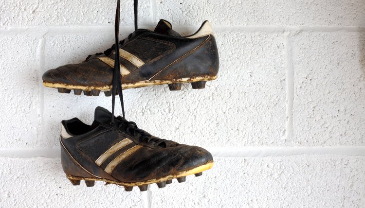 Football boots hang in a changing room