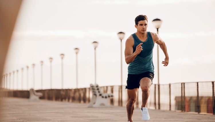 Male runner sprinting outdoors in morning