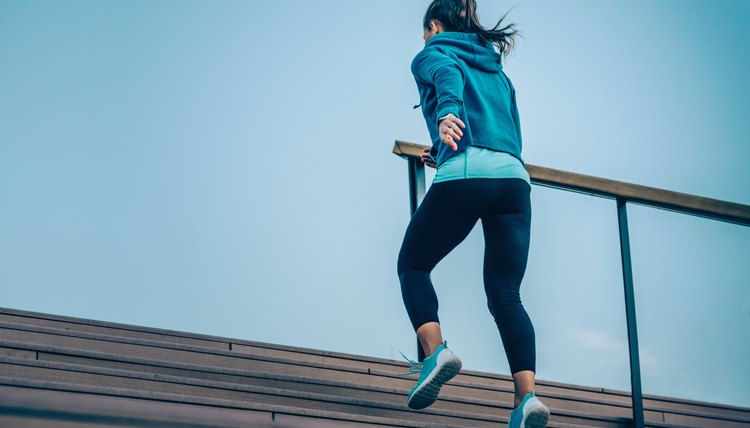 Urban fitness. Woman jogging up the stairs