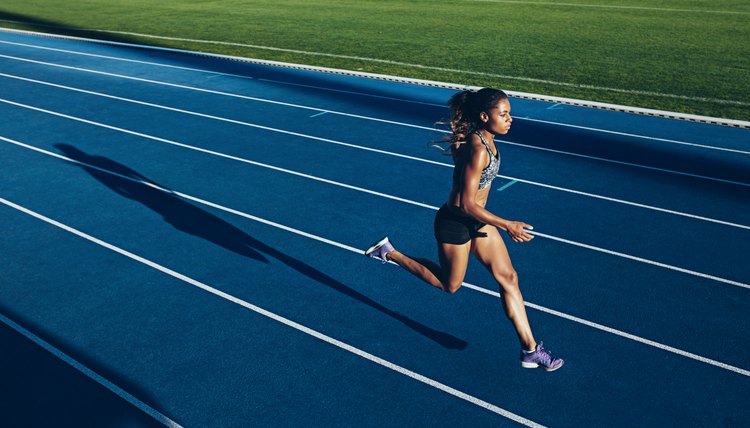 African woman running on racetrack