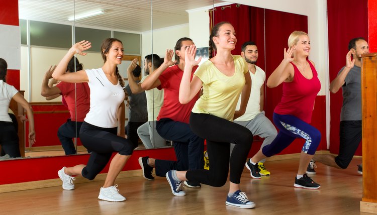 Happy people dancing in gym