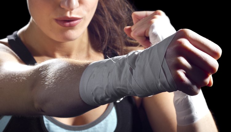 A female MMA fighter giving a strong punch