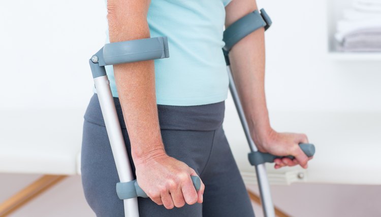 Woman standing with crutch