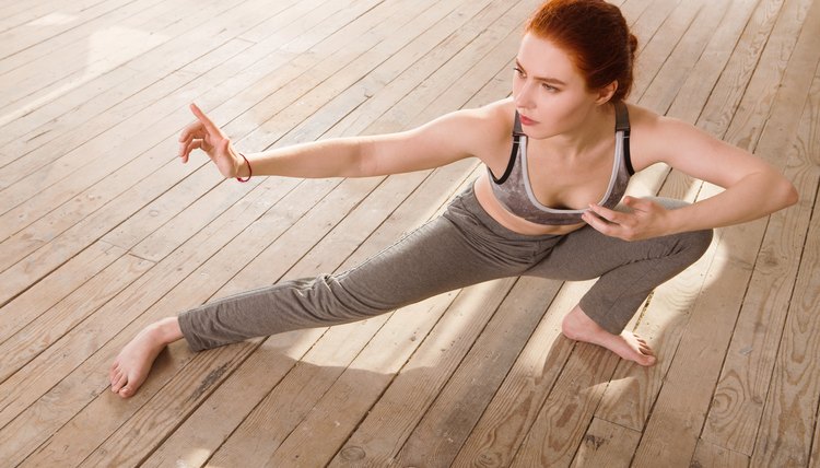 Woman praticing tai chi chuan in the gym.