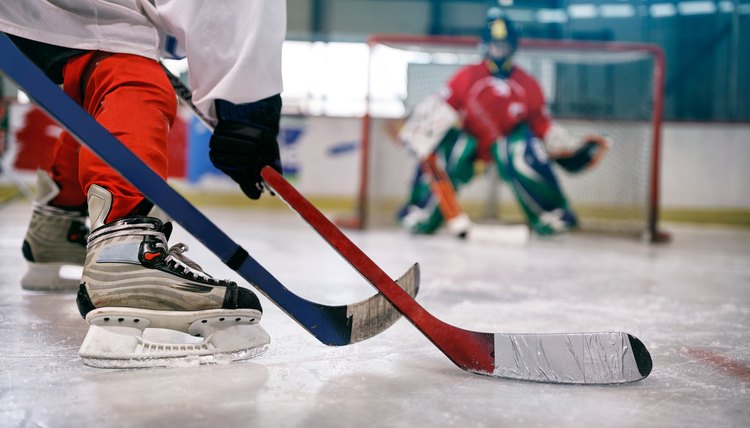 ice hockey player in action kicking with stick