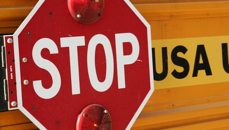 Drivers must stop when the stop sign is extended.