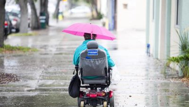 Wheelchair-bound woman riding home in Miami, FL.