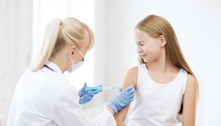 A doctor is with a young girl in a pediatric hospital.