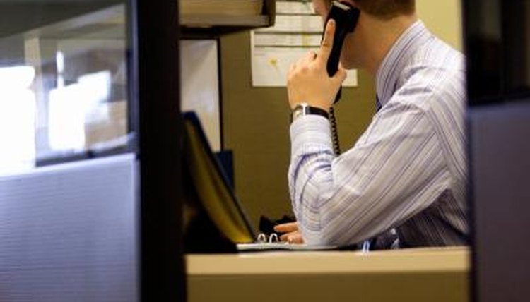 An agent on the phone in a cubical.