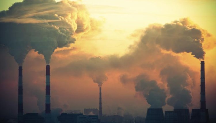 Smoke coming out of several smoke stacks.