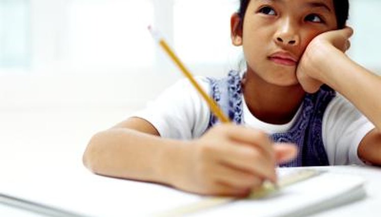 Elementary student writing down her observations