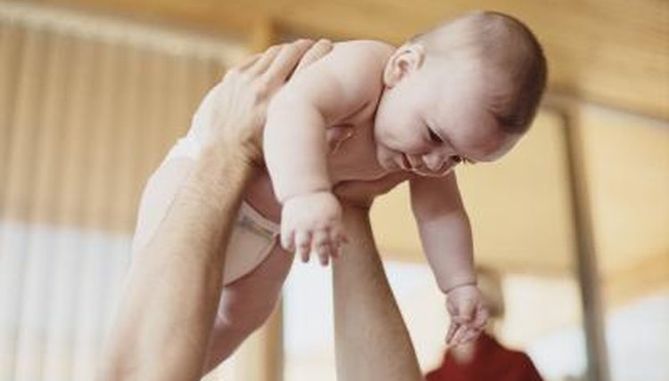 Father holding baby in air