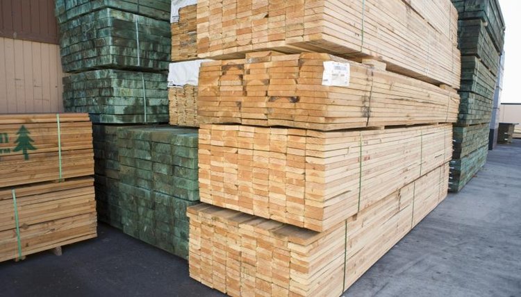 Stacks of lumber outside a warehouse