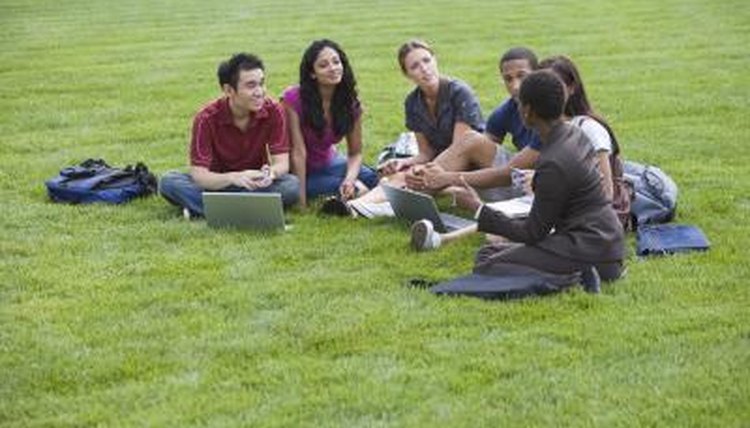 Students with a professor on a campus lawn