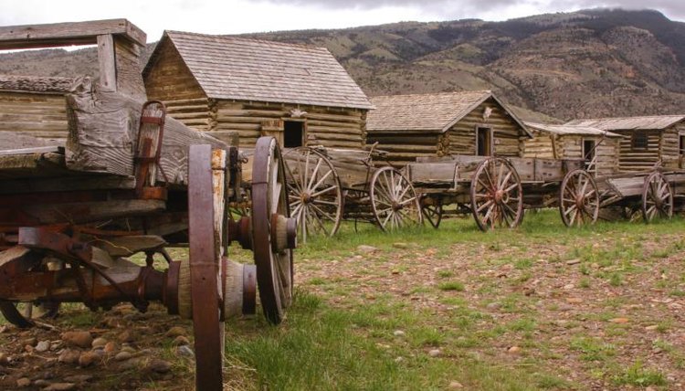 A row of cabins and wagons at a historic site along the Oregon Trail.