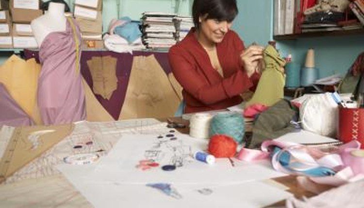 Female fashion designer working and smiling.
