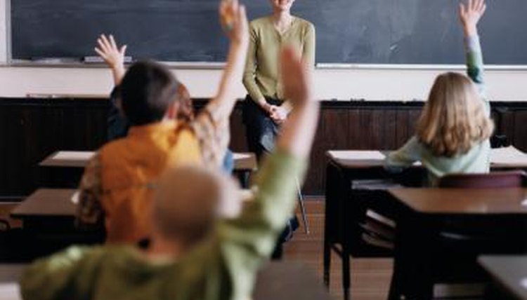 Kids raising hands in class