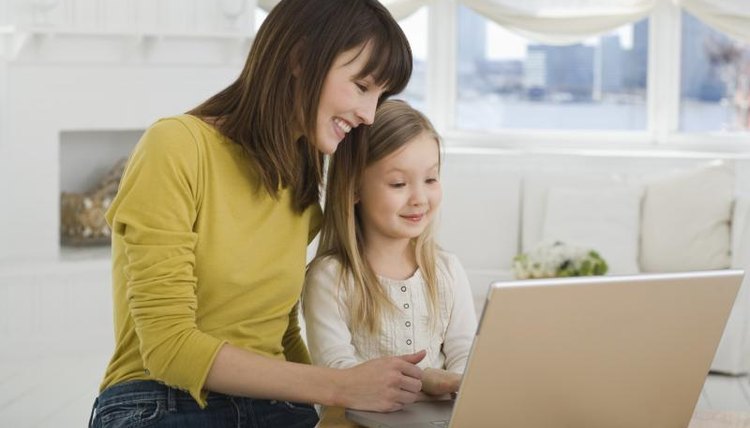 Mother and daughter using laptop
