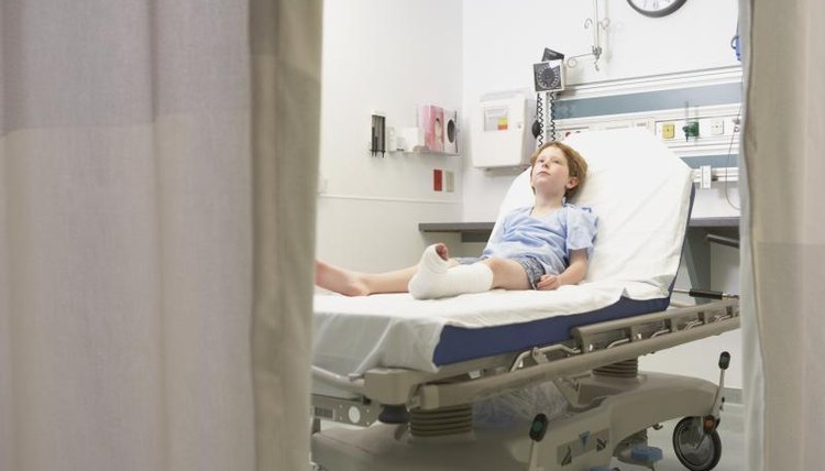 Child in hospital bed with broken leg cast.