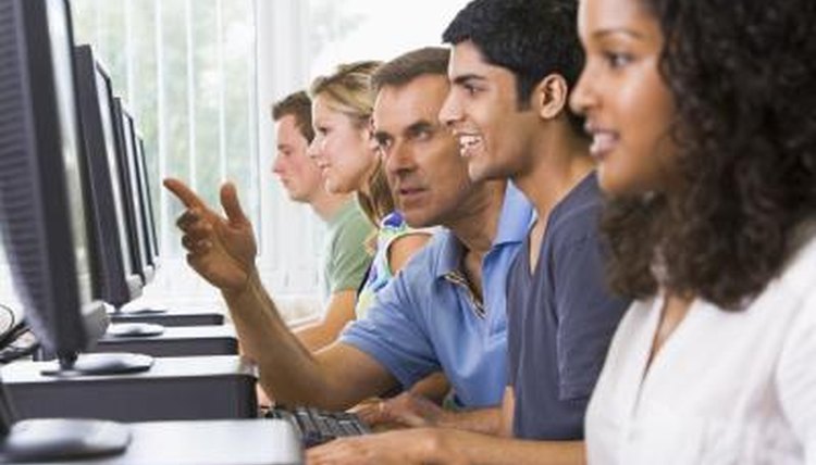 College students learning meteorology programs with help of professor.