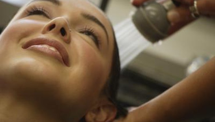 A lady is getting her hair shampooed at a salon.
